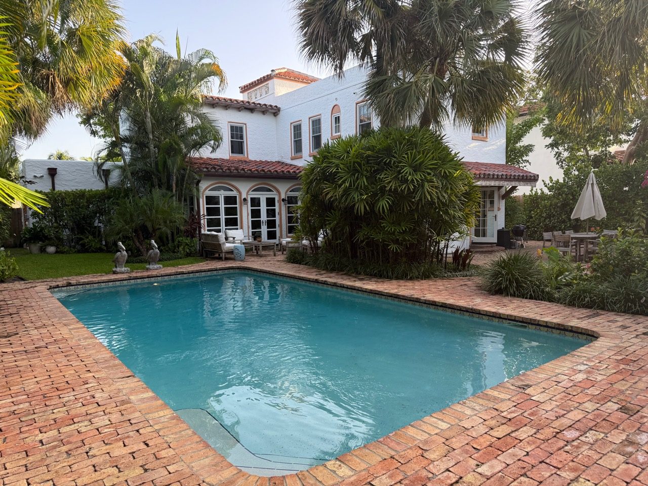 Back of the private house with the pool and palms in West Palm Beach